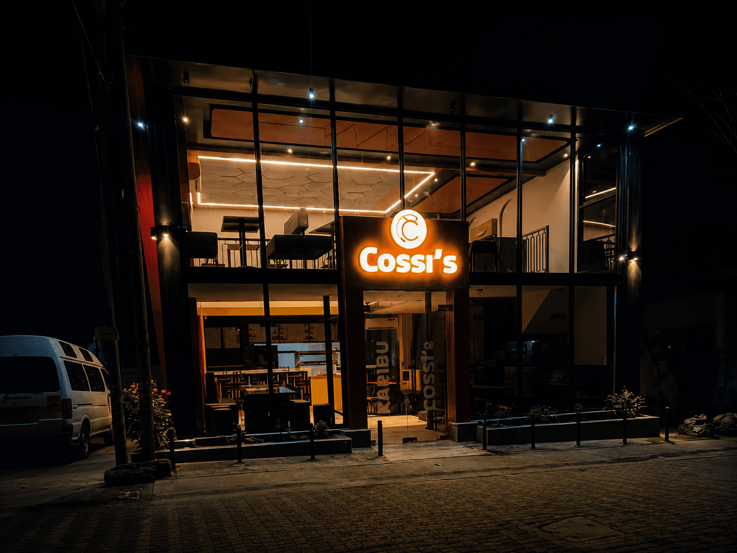 Cossi's restaurant lit up at night